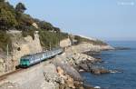 An ALe801/940 unit approaches Cervo whilst working Regionale train 6210, the 1340 Savona-Taggia Arma, 13 March 2012