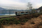 In den japanischen Alpen - der erste Zug morgens um halb 7 am Aoki-See, die Berge noch ganz im nächtlichen Dunst. Zugskomposition E 127-108. 21.April 2022 