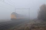 W�hrend sehr tr�bes und nebliges Wetter fahrt einem Koploper mit IC 1625 Schiphol-Enschede bei Holten am 19-11-2012.