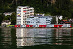 1016 014 schiebt ihren REX zwischen Lochau und Bregenz am Bodensee entlang.