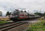 1116 138-9 ``Heeres-Sport`` zieht am 4.7.2013 den �BB EC Bregenz-Wien west, hier am Bahn�bergang Niederaudorf Richtung Rosenheim.