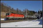 1144 098 mit Güterzug zwischen Semmering und Steinhaus am 21.01.2020.