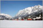 Vor dem mchtigen Tennengebirge ist 1144 205 mit REX 1506 (Salzburg-Wrgl) an diesem herrlichen Wintertag bei Pfarrwerfen unterwegs.