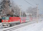 Die vereiste 1144 104 mit einem REX nach Wrgl bei Salzburg-Sd.