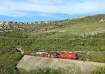 1216 142 approaches Hrastovljah whilst hauling a car train from the Port of Koper, 12 April 2016