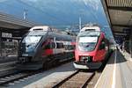 Während ÖBB 4024 080-6 als REX nach Wörgl auf Gleis 6 im Hauptbahnhof von Innsbruck stand, wartete am Nachmittag des 30.06.2018 der ÖBB 4024 085-5  mastercard  als REX nach Brenner/Brennero auf Gleis 5 auf seine Ausfahrt.