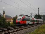 Der 4024 086 am 22.08.2009 unterwegs bei Strmenden Regen bei Niederaudorf. 