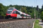 4024 117 am 13.07.2010 als REX1709(Friesach - Villach Hbf)bei der Fahrt zwischen Klagenfurt Lend und Krumpendorf. Im Hintergrund der 67 m hohe Schrotturm, ein Krntner Industriedenkmal.