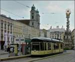 Der schne nostalgische Wagen 501 der Pstlingbergbahn harmoniert hervorragend mit dem Stadtbild am Hauptplatz in Linz.