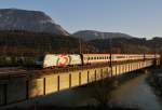1116 264-3 ``Hitradio �3`` der �BB �berquert am 12.11.2013 am sp�ten Nachmittag bei Sonnenuntergang die Innbr�cke bei Kirchbichl mit einem IC von Landeck nach Wien West.