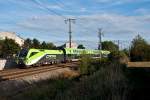 1116 141 fhrt mit dem CAT nach Wien Schwechat. Die Aufnahme entstand am 12.09.2011 kurz vor der S-Bahnhaltestelle Wien Zentralfriedhof.