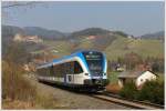 5063 008, der einzige GTW der GKB in blauem S-Bahn Design, am 13.3.2012 als R 8557 von Graz ber Lieboch nach Wies, auf der Leibenfelder Hhe mit Blick auf die Burg Deutschlandsberg aufgenommen.