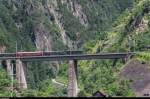 Dampflok-Spektakel am Gotthard - das offiziell letzte Mal Dampf an der Gotthard-Bergstrecke. Rückfahrt aus dem Tessin am 29. Juni 2015, hier bei der Überfahrt des Chärstelenbachviadukts oberhalb von Amsteg. Am Zugschluss des von der 141 R 1244 gezogenen Zug hängt die Ae 6/6 11407  Aargau . Das Bild könnte mit etwas passenderen Wagen auch einen historischen Gotthardschnellzug zeigen.