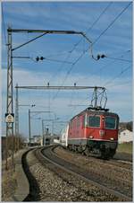 Der schöne, alte Fahrleitungsmast kommt bald weg, der Zug selbst verkehrt auch nicht mehr: Re 4/4 II 11121 mit dem EN 273 Barcelona - Zürich bei Neyruz.