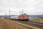 Die Re 4/4  11303 überführte am 7.2.2024 zwei Wagen von Railadventure von Basel nach Chavornay, hier bei der Durchfahrt in Frenkendorf. 