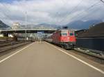 Re 4/4 11215 mit einem Reisezug in Brunnen.