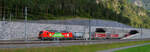 Ein DB Vectron 193  Das ist Grün  kommt mit einem KLV-Zug aus dem Nordportal des Gotthard-Basistunnels bei Erstfeld.