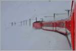 R827 mit HGe 4/4 II im Schneesturm am Oberalppass oberhalb von Nätschen.