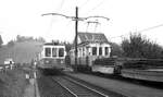 VBW Vereinigte Bern-Worb-Bahnen__Steuerwagen 244 von 1952 und Tw 39 von 1919 mit zwei Niederbordwagen, beladen mit alten Stahlschwellen, in der Station 'Langenloh'.__27-08-1976