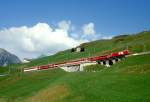 MGB exFO GLACIE-EXPRESS A 900 von Brig nach Disentis am 24.08.1997 unterhalb Ntschen auf der Kantonalstraenbrcke mit E-Lok HGe 4/4II 107 - RhB B 2435 - B - B - BVZ B - AS.