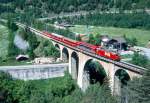 MGB FO-GLACIER-EXPRESS C 904 von Zermatt nach Davos Platz/St.Moritz am 23.05.1993 auf Rhone-Viadukt bei Grengiols mit FO-Zahnrad-E-Lok HGe 4/4II 107 - BVZ AS 2013 - RhB B -  BVZ A - FO B.