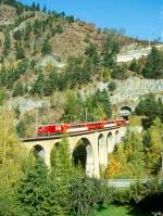 MGB FO-GLACIER-EXPRESS G 903 von Davos Platz nach Zermatt am 11.10.1996 auf Viadukt von Grengiols mit FO-Zahnrad-E-Lok HGe 4/4II 103 - FO AS 4024 -  RhB B 2428 - FO AS 4022 - RhB B 2421. Hinweis: Zug kommt gerade aus den 595m langen Grengiols-Kehrtunnel mit ber 50m Hhendifferenz Tunneleingang/Tunnelausgang, FO-Fahrzeuge noch alte Lackierung!

