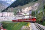 MGB FO-REGIONALZUG 229 von Gschenen nach Disentis am 28.05.1992 Ausfahrt Andermatt mit Zahnradtriebwagen Deh 4/4I 54 - B 4277 - B 4278 - ABt 4154. Hinweis: Fahrzeuge noch in alter Lackierung.
