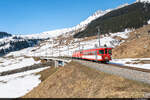 Am 27.03.2022 ist MGB Deh 4/4 23 unterwegs mit einem Autozug nach Sedrum und konnte hier bei Rueras aufgenommen werden