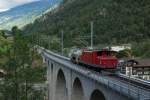 HGe 4/4 15 folgt am 30.06.2014 dem Jubiläums-Dampfzug mit einem Löschwagen. Das Bild des Dampfzuges ist leider nichts geworden, da der Wind den Rauch genau in meine Richtung blies und ich den Zug nicht mehr sehen konnte. Aufgenommen auf dem Grengiolsviadukt.