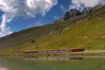 Der FO HGe 4/4 Nr.36 fährt gerade mit dem Swiss Alps Classic Express,der von Zermatt nach St.Moritz unterwegs ist,aus dem Zahnstangenabschnitt am Oberalpsee raus.Bild vom 11.8.2015