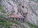 Der R 617 (Göschenen - Andermatt) verlässt hier soeben den Jostbach-Tunnel um kurze Zeit später den Bahnhof Andermatt zu erreichen. (23.7.2015)