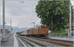 Die Blonay Chamby  Bernina Bahn Ge 4/4 81 bei der Rückfahrt nach Blonay mit ihrem  Riviera Belle Epoque  fährt in St-Légier Gare durch. Trotz grundlegendem Umbau der Station St-Légier Gare steht das Ensemble des schönen grossen Baums sowie des kleinen Stationsgebäude weiterhin an ihren Platz. 

9. Juni 2019