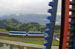 Eine Garnitur mit Bestimmung Arth-Goldau im Bahnhof Rigi Kulm. Im Vordergrund die Skulptur  Take the A Train . Aufgenommen am 3.August.2011.