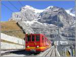 Vor der Kulisse des Eigers (die Nordwand befindet sich links hinter dem Grat) wartet BDhe 2/4 209 von 1964 in neuer JB Bemalung auf einen bergwrts fahrenden Zug. (11.10.2007)