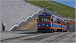 Der Monte-Generoso Bahn Bhe 4/8 11 im Gipfelbahnhof Generoso Vetta, welcher durch den Bau der  Steinblume  von Mario Botta sehr aufgeräumt wirkt.
