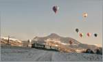  Morgenstund hat Gold im Mund , aber auch Schatten im Tal; besonders im Winter; so genossen die Ballonfahrer schon die Sonne während der MOB GDe 4/4 6001  Vevey   mit ihrem  Regionalzug 2213 (und