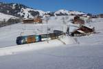 Ge 4/4 8002 fährt am 27.12.2013 mit dem GoldenPass Panoramic 3115 von Gruben Richtung Gstaad.