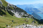 Einzigartiger Blick auf die wundersch�ne Landschaft in der Zentralschweiz mit den vielen Bergen und dem Vierwaldst�ttersee. Im Vordergrund sind die beiden Doppeltriebwagen unterwegs in Richtung Bergstation Pilatus Kulm. Das Foto wurde von einem Wanderweg aus gemacht. Pilatus Kulm, 19.8.2026