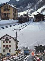 Der Bahnhof Klosters Dorf im Februar 1981 und am 01.04.2022: Auf der oberen Aufnahme kommt die Ge 6/6 II 704 mit einem Zug aus Landquart an, darunter durchfährt die Ge 4/4 II 619 den Bahnhof mit