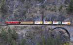 RhB Ge6/6'' 704 hauling a freight train on the Albula line, just after the landwasser viadukt, near Filisur, on the 2nd of May in 2008