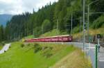 Der RE 1152 von St. Moritz macht sich auf den Weg, weiter in Richtung Chur. Hier zu sehen am 24.7.2014 bei der Ausfahrt aus dem Bahnhof Bergün/Bravuogn. Zuglok war die Ge 4/4 III 644  LAZZARINI .