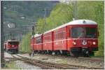 Die S8 mit Be 4/4 und Steuerwagen 1716 berholt die Ge 6/6 II 702  Curia  bei Landquart Ried. (30.04.2009)