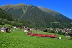 Ge 6/6 II 706 mit einem Regio am 04.09.2019 bei Klosters Dorf.