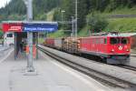 RhB Ge 6/6 II 701  Raetia  wartet am 29.7.2014 in Bergn mit einem Gterzug auf die Ausfahrt Richtung St.Moritz