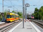 BLT/SBB - Tram Be 4/8 254 unterwegs auf der Linie 10 und der ICN Mani Matter bei der durchfahrt im Bahnhof Dornach am 29.04.2010