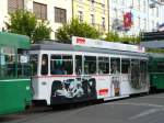 BVB - Tramanhnger mit Werbung fr eine Schweizer Uhrenmarke andere Seite mit Anderem Motiv bei der Haltestelle vor dem SBB Bahnhof von Basel am 29.04.2007