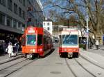 VBZ / FB - Werbetram Be 4/6 2005 neben FB Steuerwagen Bt 203 bei der Haltestelle in Zrich Stadelhofen am 01.04.2011