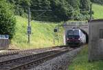 Eine Vectron von SBB Cargo international zieht einen Güterzug aus dem sehr alten Tunnel bei Burgdorf. Aufgenommen 2024 an der klassischen Stammstrecke der SBB, Zürich - Bern - Lausanne von einem Parkplatz neben dem Geleise aus.