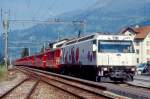 RhB Schnellzug 35 von Landquart nach Davos Platz am 23.08.1997 in Schiers mit E-Lok Ge 4/4 III 649 - D 4226 - A 1242 - B 2371 - B 2381 - B 2427 - B 2372 - B 2444 - B 2355 - AB 1520. Hinweis: Lokwerbung inzwischen gendert 
