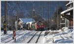 Dicht hinter der S1 folgt ein Gterzug nach Davos mit der Ge 6/6 II 706  Disentis/Mustr . (23.12.2011)